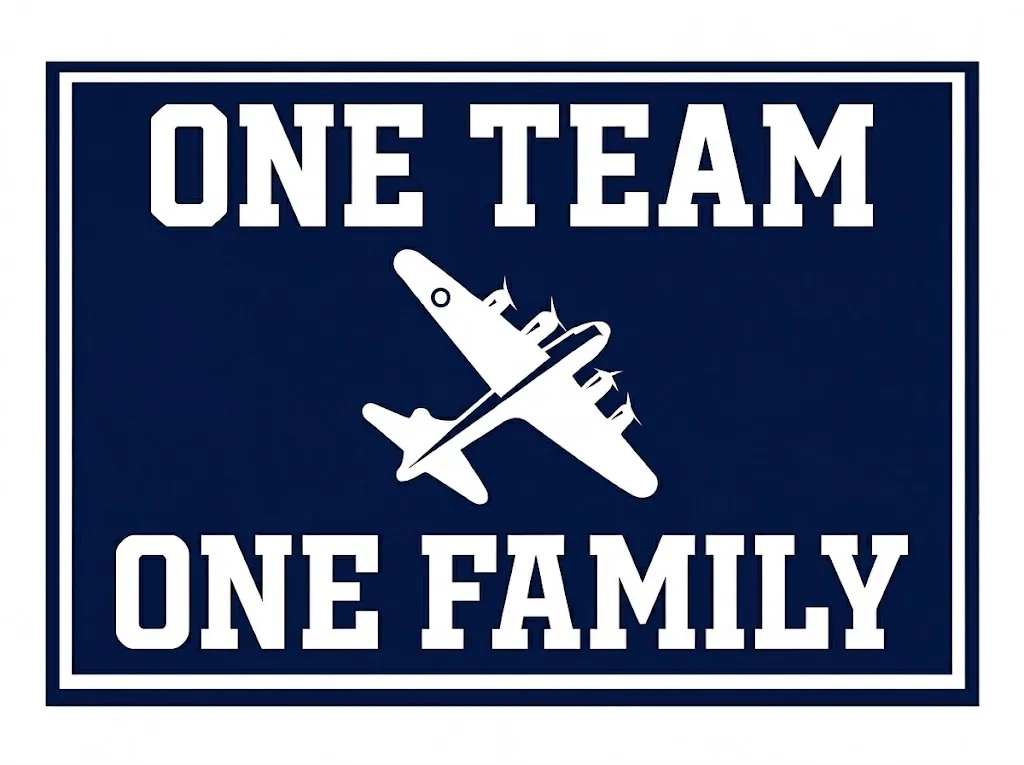 Navy and white Pine Plains Bombers sign with the message One Team, One Family and a bomber plane.